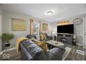 Bright living room with a decorative fireplace and plush seating at 1907 N Drexel Ave, Indianapolis, IN 46218