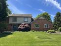 Charming two-story home with blue door and well-manicured lawn at 1941 Spruce Dr, Carmel, IN 46033