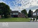 Two-story home with brick and siding exterior plus a well-maintained front lawn at 1941 Spruce Dr, Carmel, IN 46033
