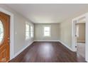 Bright living room featuring beautiful hardwood floors and large windows at 203 S 17Th Ave, Beech Grove, IN 46107