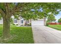 Beautiful home featuring a well-maintained lawn and a spacious driveway leading to an attached garage at 2070 Mustang Chase Dr, Carmel, IN 46074