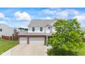 Charming two-story home boasts a brick facade, attached two-car garage, and mature tree at 2337 Hanover Rd, Brownsburg, IN 46112