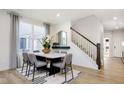 Bright dining room with stylish table, chairs, modern lighting, and large window views at 2598 Penn Ave, Plainfield, IN 46168