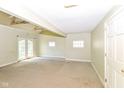 Bright living room featuring French doors, ample natural light, and neutral wall colors at 31 E Mill St, New Palestine, IN 46163