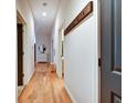 A light-filled hallway features wood floors, coat rack, and neutral walls at 350 N Meridian St # A303, Indianapolis, IN 46204