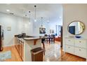 Open-concept kitchen with granite countertops, stainless appliances, flows to the living area at 350 N Meridian St # A303, Indianapolis, IN 46204