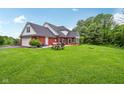 Spacious backyard with patio area, picnic table, and mature trees at 3564 Clear Creek Blvd, Martinsville, IN 46151