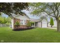 Charming single-story home with brick accents, manicured lawn, and attached two-car garage at 374 Pomona Ct, Greenfield, IN 46140