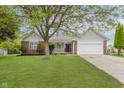 Inviting single-story home featuring a well-maintained lawn and attached garage at 374 Pomona Ct, Greenfield, IN 46140