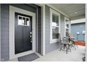 The cozy front porch has outdoor seating and offers a welcoming entrance to the home at 395 Ehrlich Ln, Westfield, IN 46074