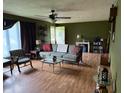 The living room features a ceiling fan, wood-look flooring, and is flooded with natural light at 409 W 3Rd St, Alexandria, IN 46001
