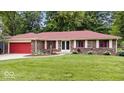 Charming brick ranch home with a well-manicured lawn and a welcoming red front door at 434 Verwood Ct, Indianapolis, IN 46234