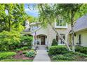Charming two-story home with stone and stucco accents, landscaped garden, and welcoming front porch at 4530 Chase Oak Ct, Zionsville, IN 46077