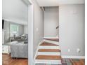 Bright stairway featuring hardwood steps and a view into the cozy living room at 4840 E 77Th St, Indianapolis, IN 46250
