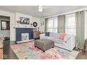 Bright living room with a decorative fireplace, plush seating, and hardwood floors at 4922 Brookville Rd, Indianapolis, IN 46201