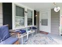 Inviting porch with comfortable seating, a colorful rug, and charming decor at 4922 Brookville Rd, Indianapolis, IN 46201