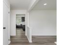View of the entryway into a home with wood flooring, white walls, and an open concept design at 5982 Melbourne Rd, Indianapolis, IN 46228