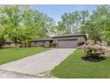Charming single-story brick home with a well-kept lawn and flowering bushes along the driveway at 5982 Melbourne Rd, Indianapolis, IN 46228