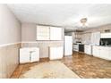 A kitchen needing repair with white cabinets and a linoleum floor at 6238 E 43Rd St, Indianapolis, IN 46226