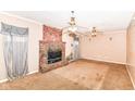 Spacious living room with a large brick fireplace and two ceiling fans at 6238 E 43Rd St, Indianapolis, IN 46226