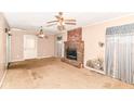 Living room with a brick fireplace, ceiling fans and beige colored carpet at 6238 E 43Rd St, Indianapolis, IN 46226