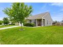 Well-maintained home with a tidy lawn and front garden, complemented by mature trees and a cozy entrance at 6415 Calabash Pl, Indianapolis, IN 46217