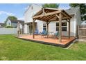 Relaxing backyard deck with a pergola, seating, and a lush green lawn at 7541 Southern Lakes Dr, Indianapolis, IN 46237