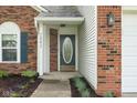 Inviting front entrance with a decorative glass door and landscaped walkway at 7541 Southern Lakes Dr, Indianapolis, IN 46237