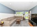 Comfortable living room with a large sectional sofa and ample natural light at 7725 E 52Nd St, Indianapolis, IN 46226
