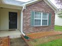 Close-up of the front entryway showcasing the brick facade, front window, and decorative shutters at 8165 Amarillo Dr, Indianapolis, IN 46237