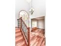 Inviting foyer featuring hardwood floors, staircase with iron railings, and a view into the living room at 8530 Ardennes Dr, Fishers, IN 46038