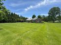 Beautiful brick home with well-maintained lawn and mature trees on a sunny day at 8711 E 296Th St, Atlanta, IN 46031
