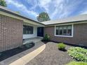 Inviting brick home entrance with a curved walkway and manicured landscaping at 8711 E 296Th St, Atlanta, IN 46031