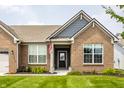 Charming home with brick facade, gray accents, and a welcoming front entrance at 9718 Haughton Ln, McCordsville, IN 46055