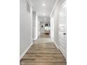 Long hallway with wood flooring, white trim, and recessed lighting leading to living area at 9718 Haughton Ln, McCordsville, IN 46055