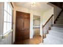 Inviting foyer features hardwood floors, a staircase, and a double-door closet at 10244 Washington Blvd, Carmel, IN 46280