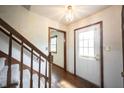 Bright foyer features hardwood floors, a staircase, and a white front door at 10244 Washington Blvd, Carmel, IN 46280