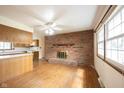 Spacious living room boasts a brick fireplace, hardwood floors, and large windows at 10244 Washington Blvd, Carmel, IN 46280