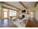 Bright and airy living room features hardwood floors, fireplace, and large windows at 10586 Jacks Way, Indianapolis, IN 46234