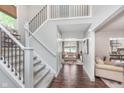 Elegant foyer featuring a staircase with iron railings and hardwood floors at 10673 Misty Hollow Ln, Fishers, IN 46038
