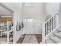 Bright foyer with a grand staircase, high ceilings, and modern accents at 10673 Misty Hollow Ln, Fishers, IN 46038