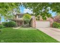 Traditional home featuring a welcoming front porch and a well maintained lawn at 10673 Misty Hollow Ln, Fishers, IN 46038