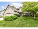 Charming two-story home with mature trees, manicured lawn, and traditional architecture at 10888 Weston Dr, Carmel, IN 46032