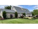 Backyard featuring a newly built deck with an outdoor seating area, manicured lawn, brick, and landscaping at 1135 W Wildflower Ct, Mooresville, IN 46158