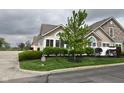 Beautifully landscaped lawn featuring lush green grass and mature trees on an overcast day at 1150 Extraordinary Trl, Greenfield, IN 46140