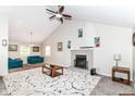 Spacious living room with vaulted ceiling, brick fireplace, ceiling fan, and contemporary furnishings at 11612 E 75Th St, Indianapolis, IN 46236