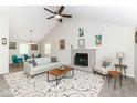 Bright living room with vaulted ceiling, fireplace, ceiling fan, and contemporary furnishings at 11612 E 75Th St, Indianapolis, IN 46236
