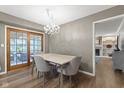 Cozy dining room with elegant chandelier and sliding door access to patio creating a warm ambiance at 11807 Rolling Springs Dr, Carmel, IN 46033