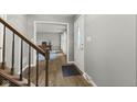 Bright foyer features wood floors, staircase, and access to a home office, creating a welcoming entry at 11807 Rolling Springs Dr, Carmel, IN 46033