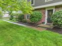 Beautiful landscaping with a brick pathway leading to the front door, enhancing curb appeal and inviting entry at 11807 Rolling Springs Dr, Carmel, IN 46033